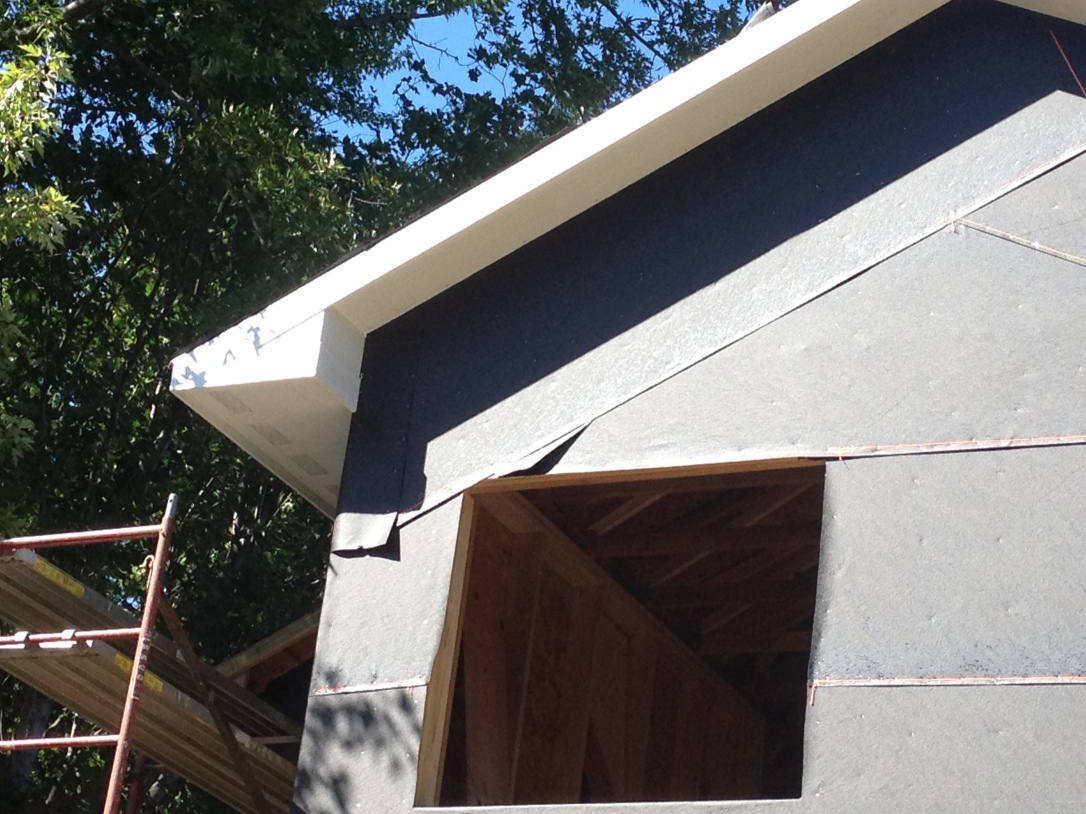 Close-up view of south side of house, framed in with soffit and facia. 